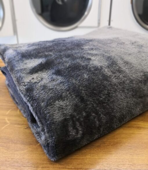 Folded clean mink blanket in laundry